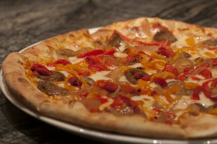 Here's a wood-fired pizza of salsiccia and peppers at Taverna Pizzeria and Risotteria on...