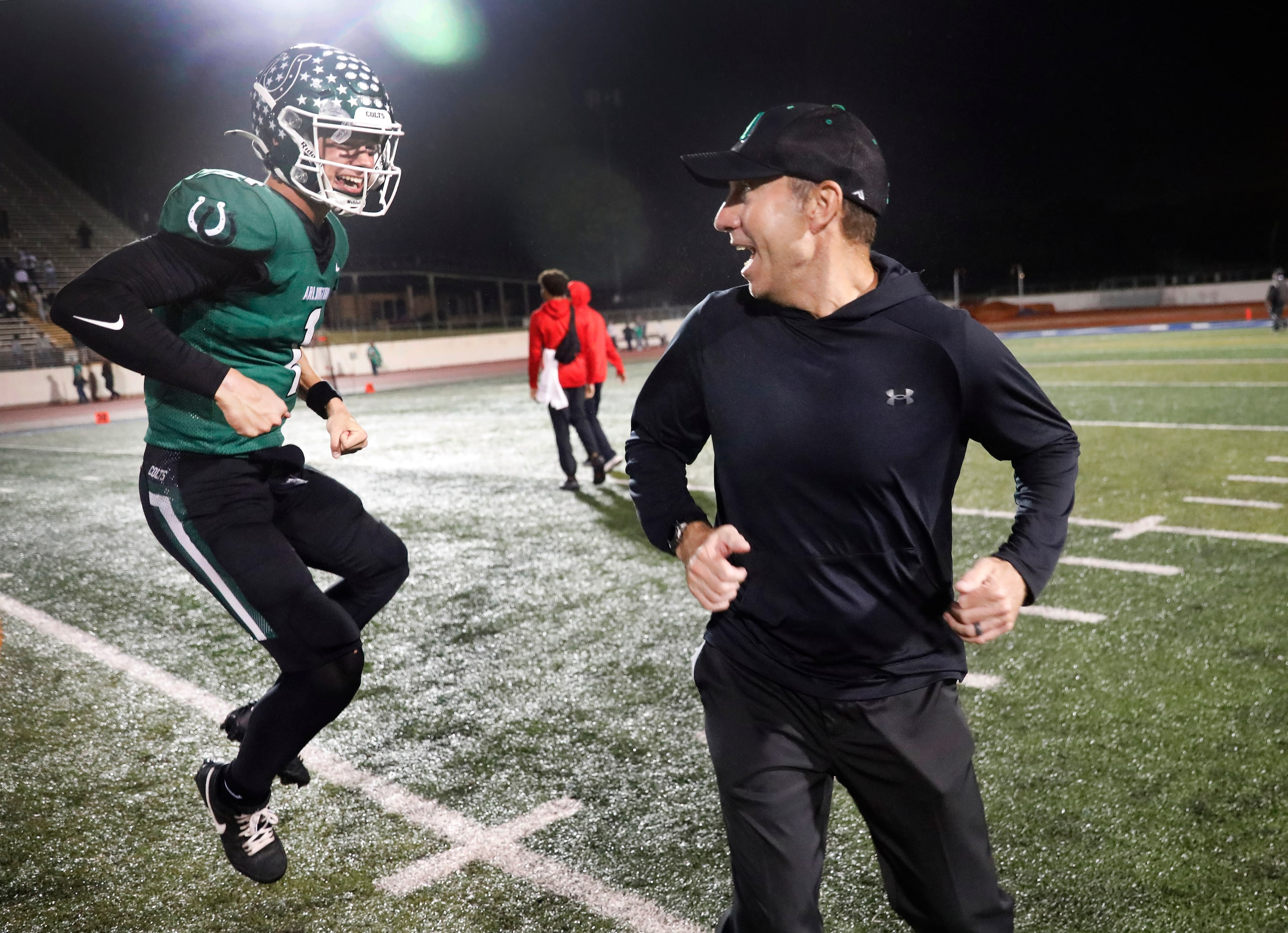 Arlington High quarterback Coleman Cravens (1) celebrates their 49-31 win over Arlington...