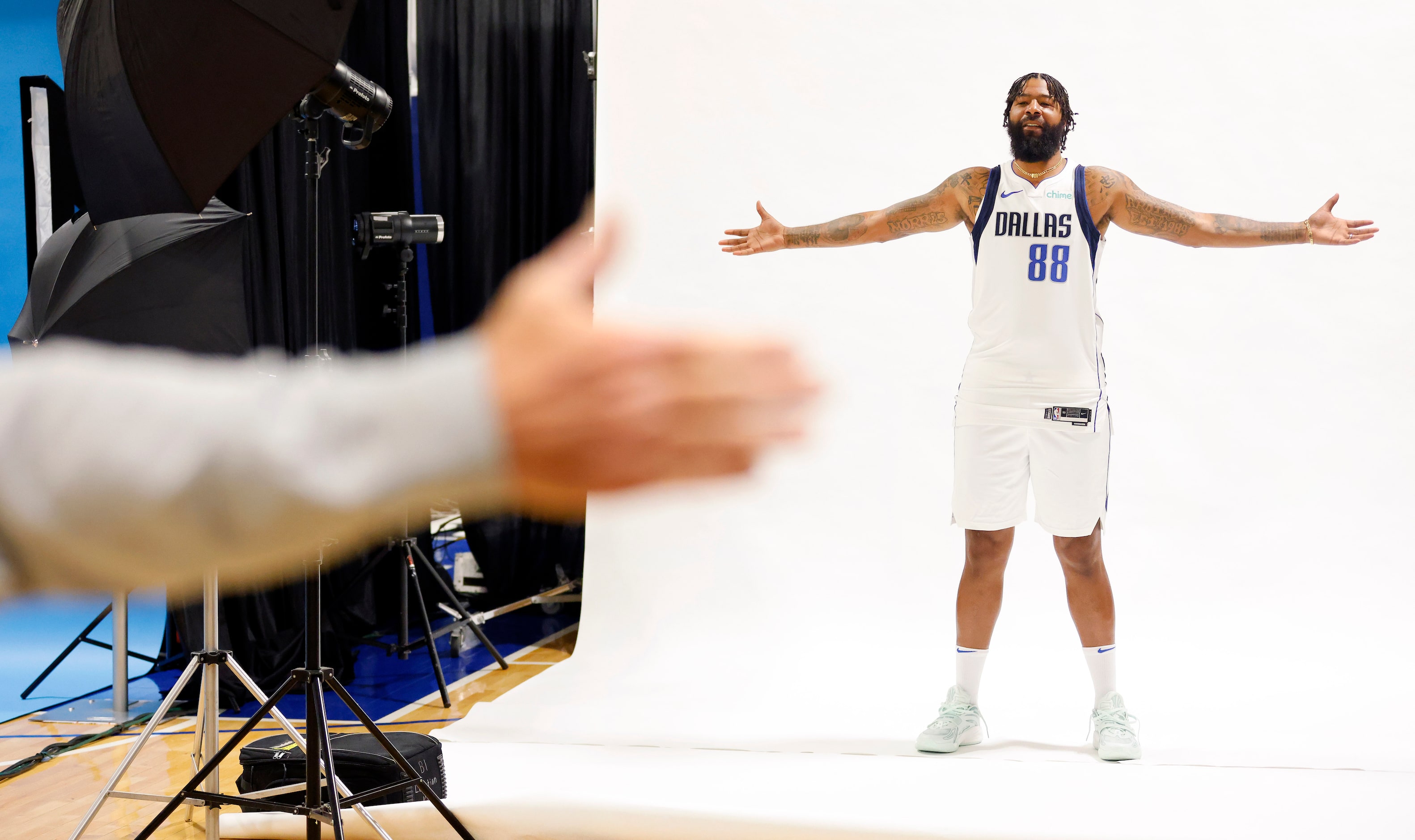 Dallas Mavericks forward Markieff Morris (88) poses for photographer Glenn James, who gives...