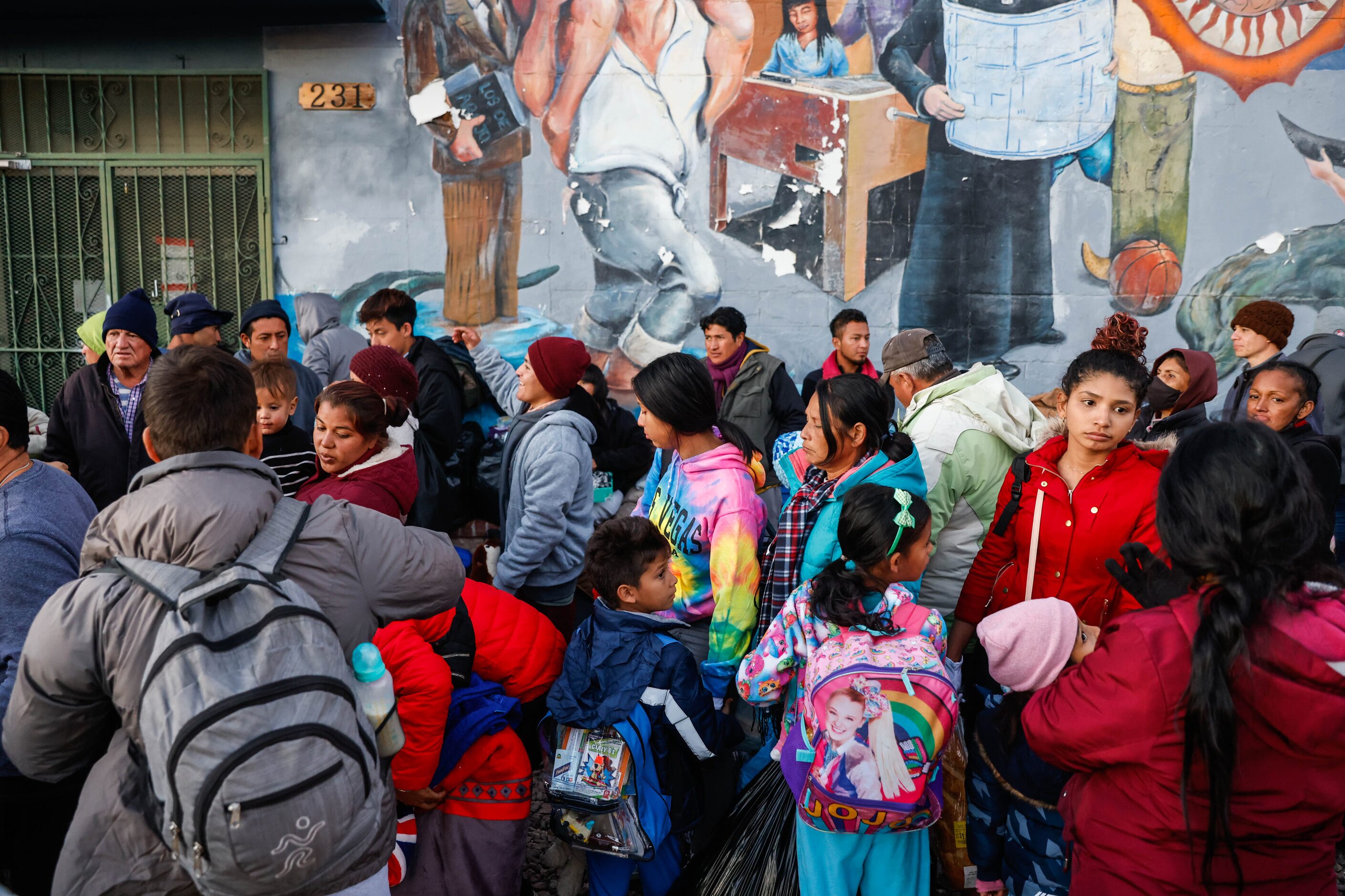 Migrants wait outside the Centro Pastoral Sagrado Corazon for the opportunity to have...