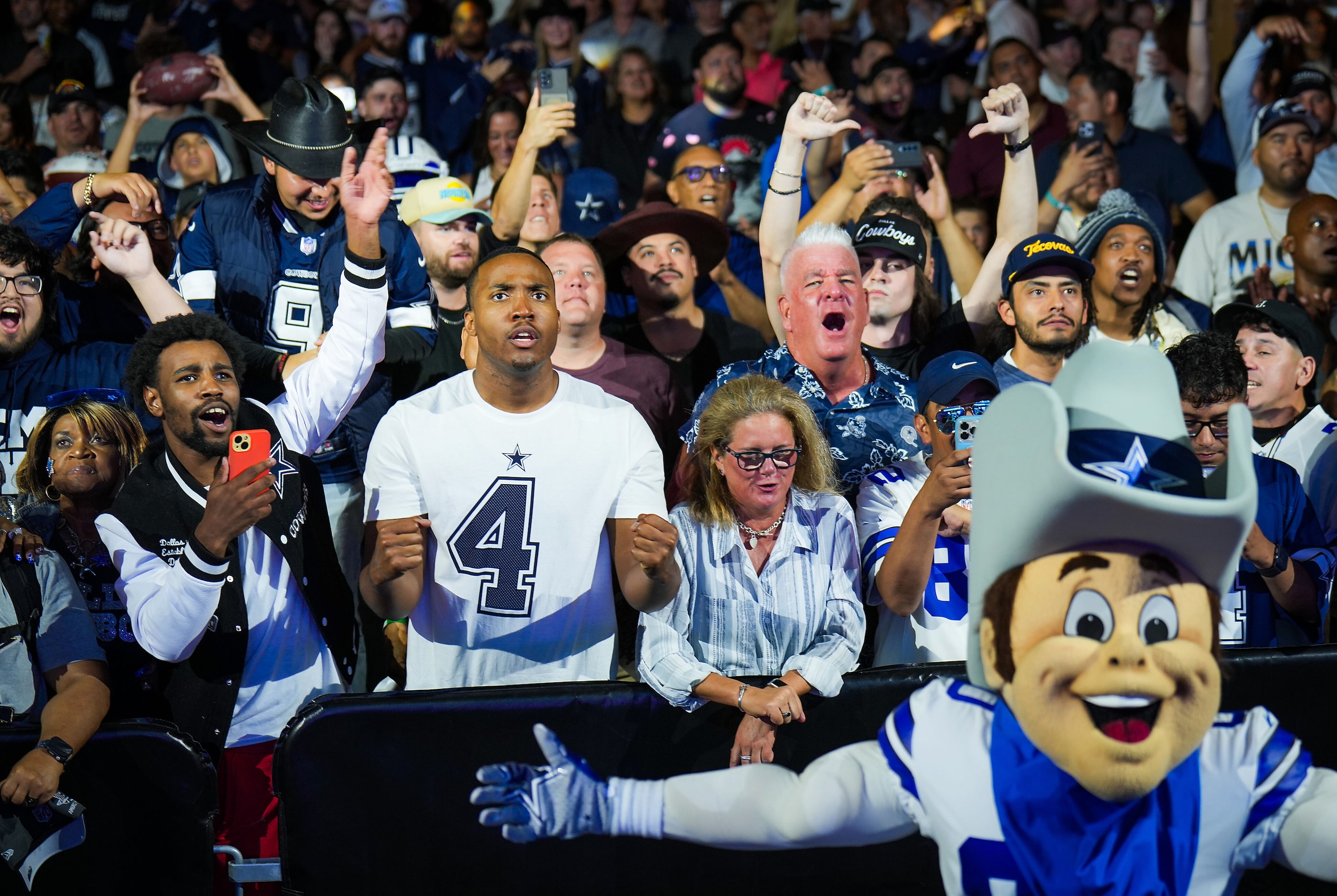 Dallas Cowboys fans react after it was announced that the team traded the 24th pick for the...