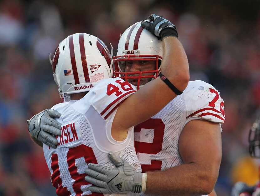 CHICAGO, IL - SEPTEMBER 17: Jacob Pedersen #48 of the Wisconsin Badgers gets a hug from...