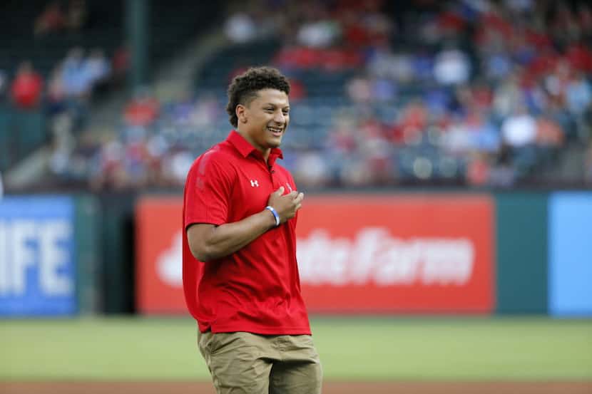 Texas Tech NCAA football quarterback Patrick Mahomes smiles after throwing out the...