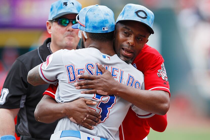 CINCINNATI, OH - JUNE 16: First base coach Delino DeShields of the Cincinnati Reds hugs his...