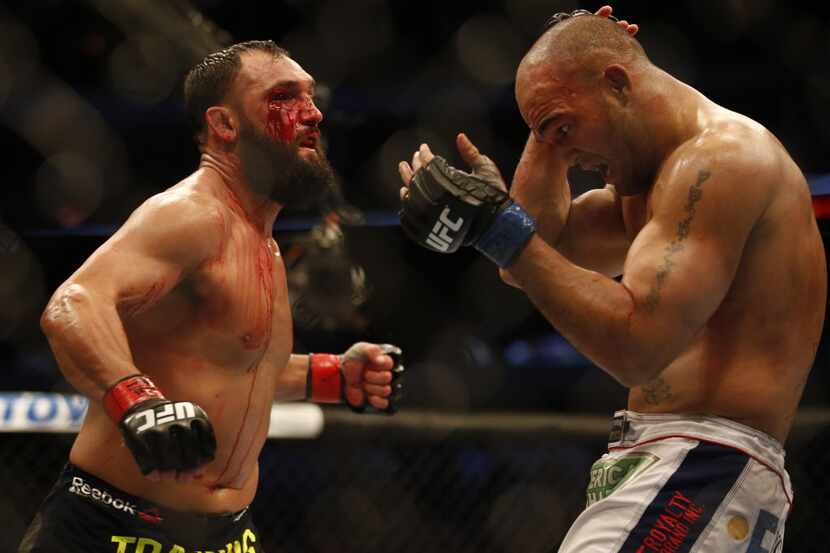 Johny Hendricks (red gloves) fights Robbie Lawler (blue) for the  UFC World Welterweight...