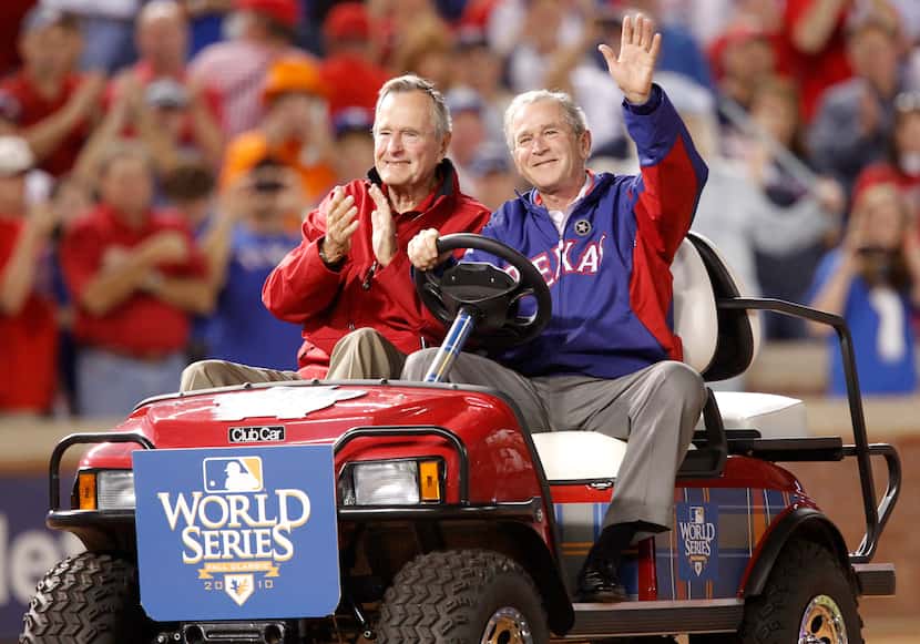 2010: Former Presidents George H.W. Bush and his son George W. Bush acknowledge the crowd...