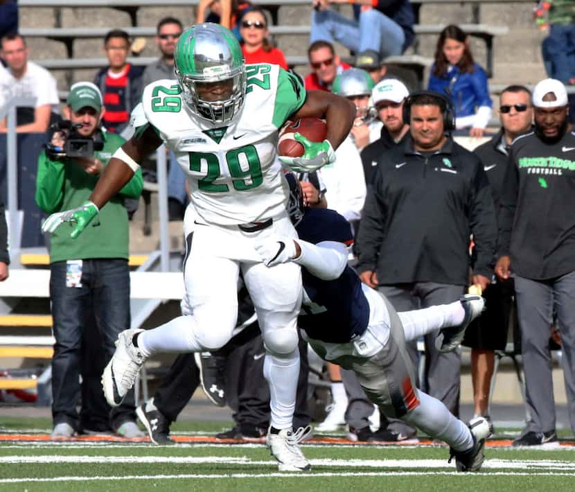 North Texas running back Willy Ivery (29) finds room to run against UTEP during an NCAA...