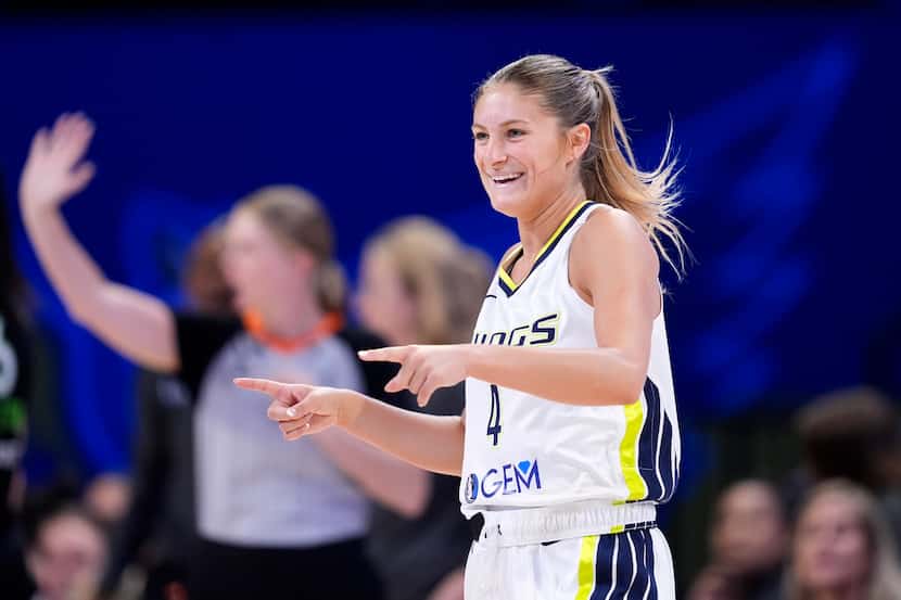 Dallas Wings' Jacy Sheldon (4) celebrates after sinking a three-point basket against the...