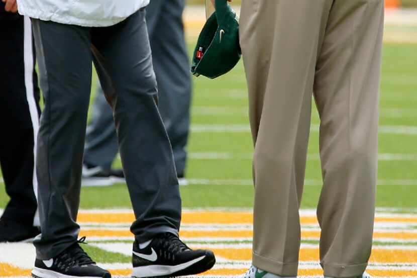 Southern Methodist head coach Chad Morris (left) shakes hands with Baylor head coach Jim...