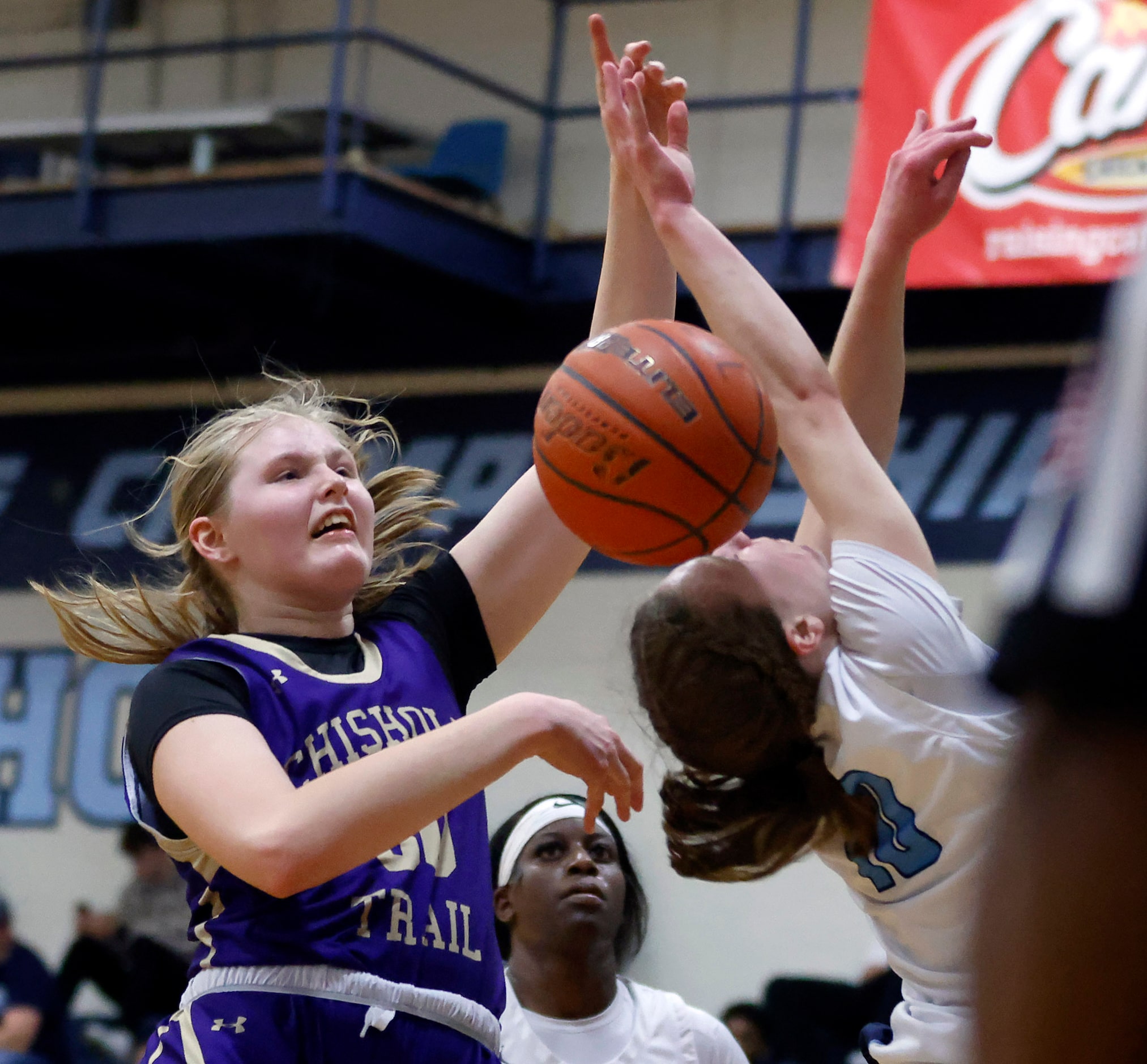 Hurst L.D. Bell’s Katelyn Tietjen (10, right) is fouled by Saginaw Chisholm Trail’s Claire...