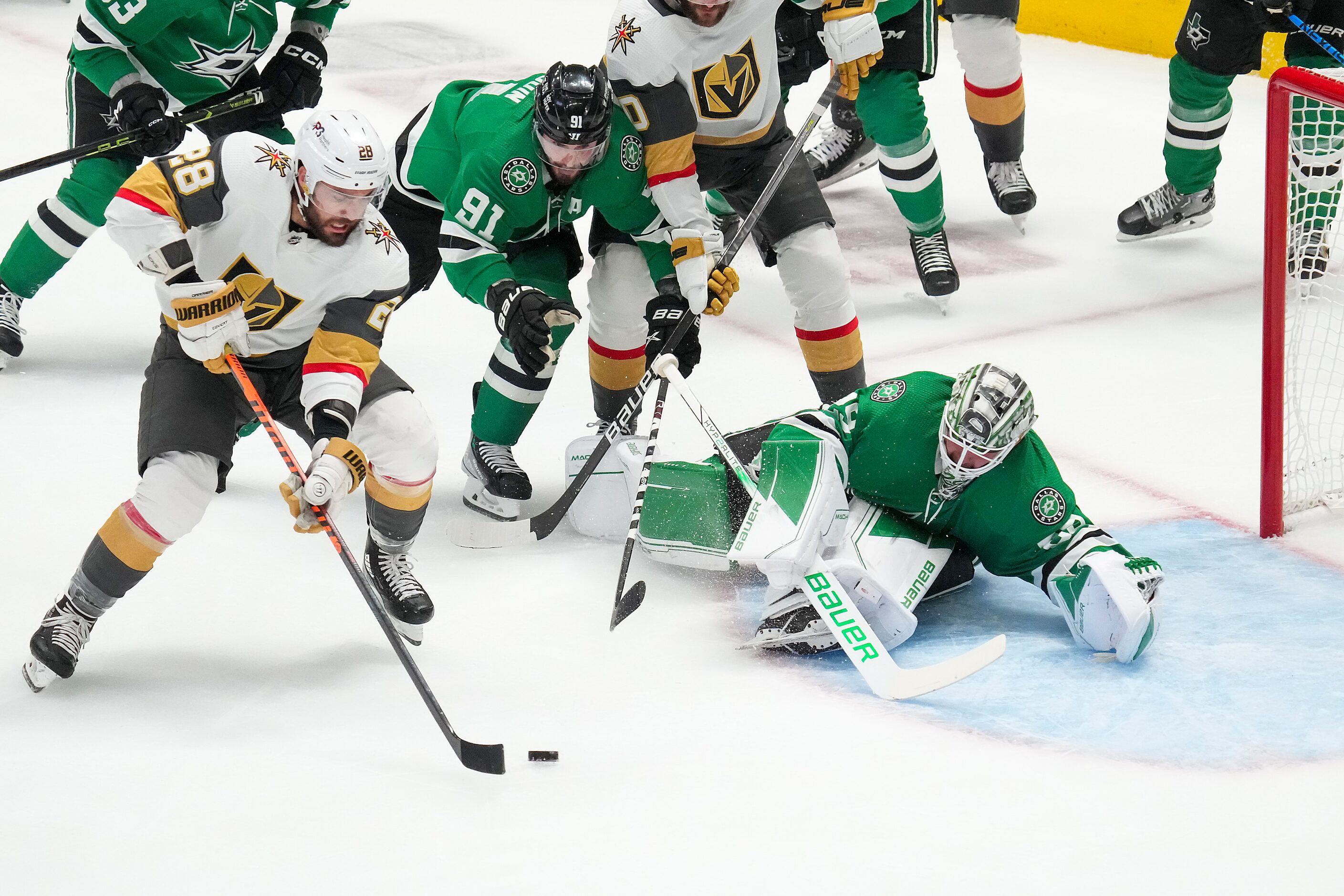 Vegas Golden Knights left wing William Carrier (28) slips the puck past Dallas Stars...