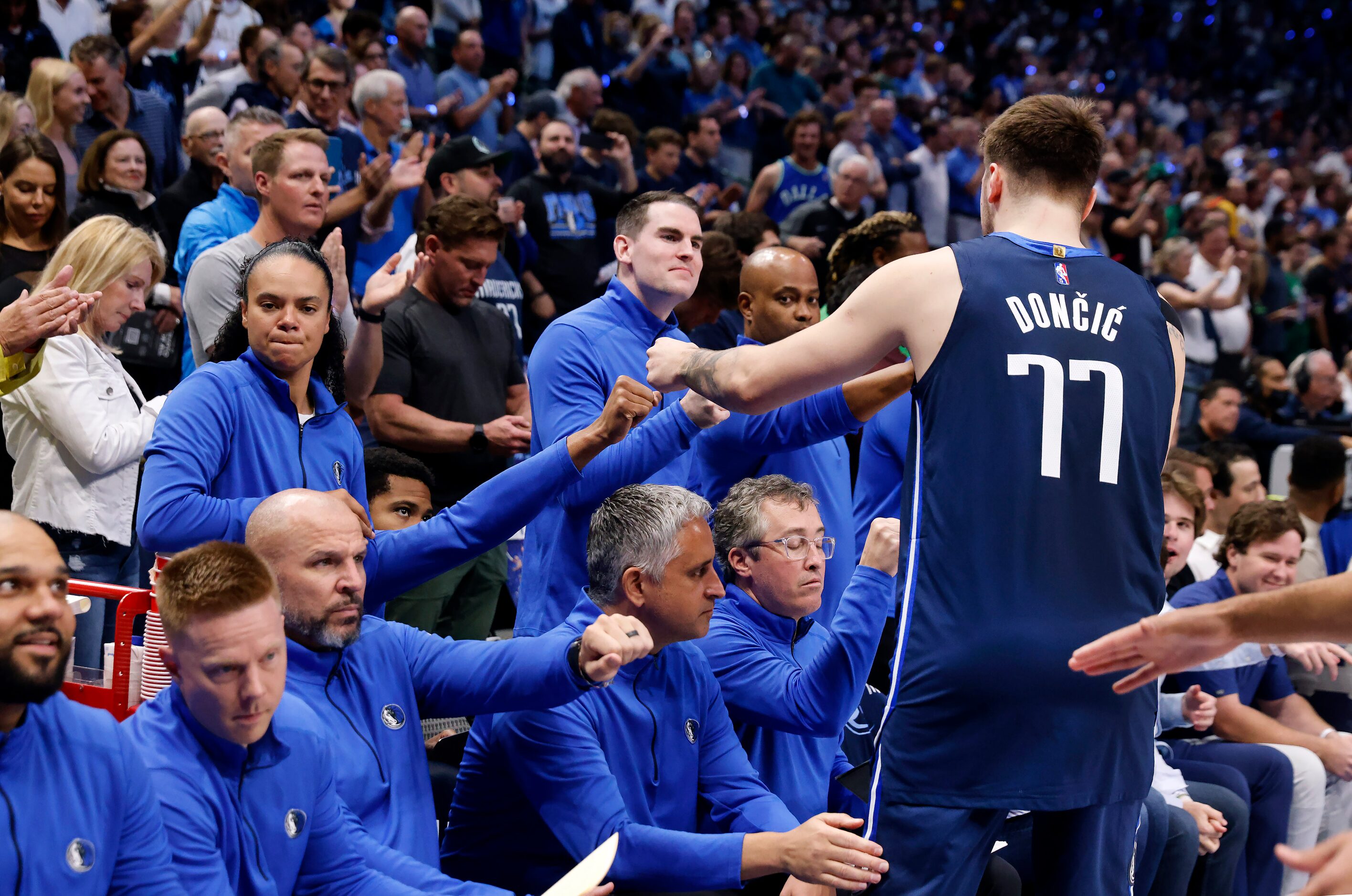 Dallas Mavericks guard Luka Doncic (77) receives first bumps from coaches before facing the...