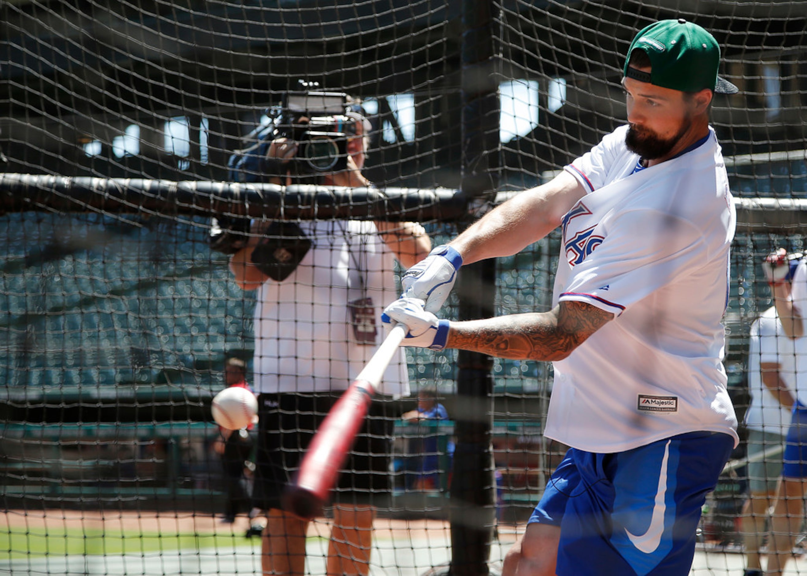 Dallas Stars captain Jamie Benn participates in a batting practice with the Texas Rangers,...