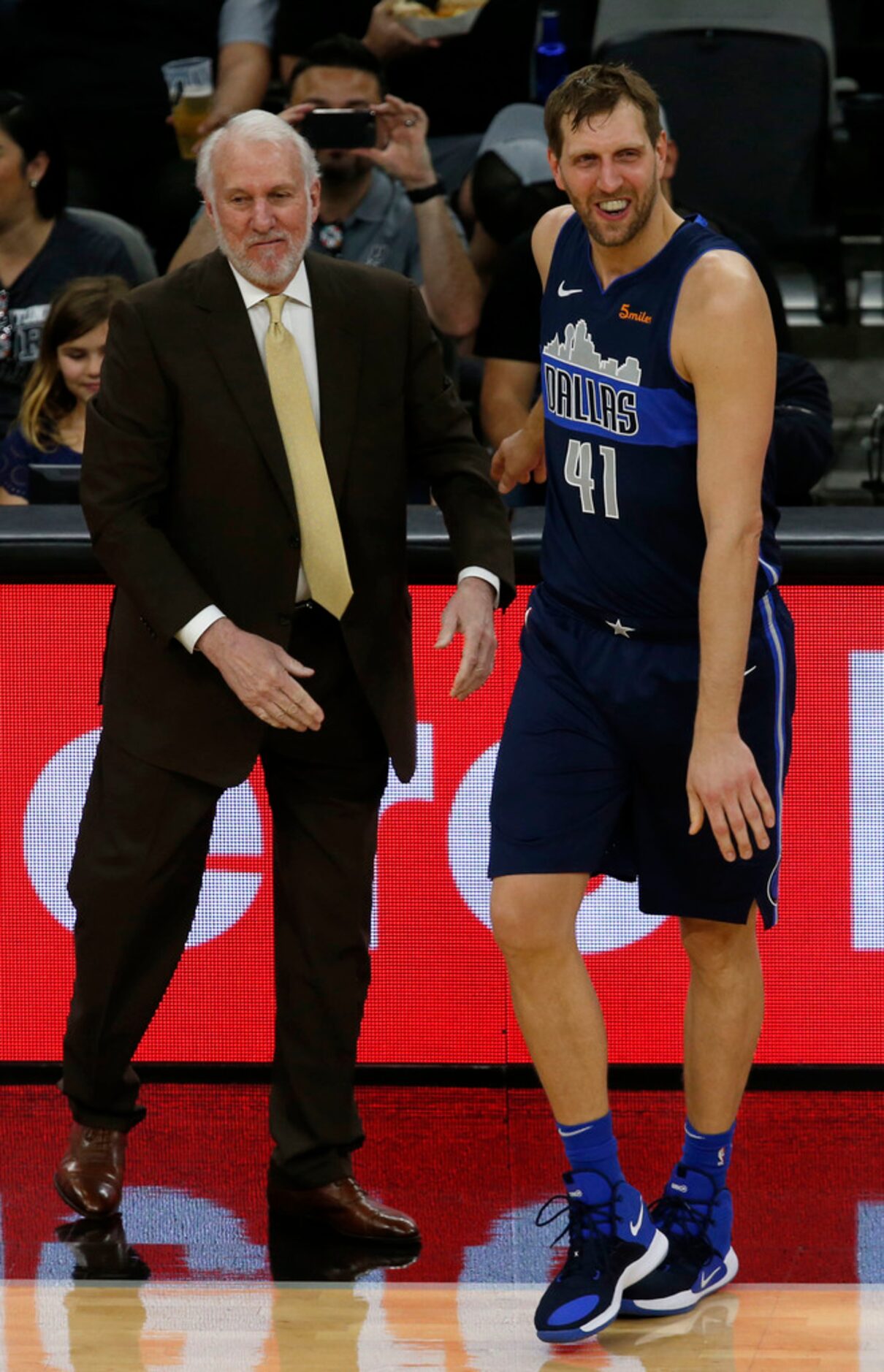 San Antonio Spurs head coach Gregg Popovich talks with Dallas Mavericks forward Dirk...