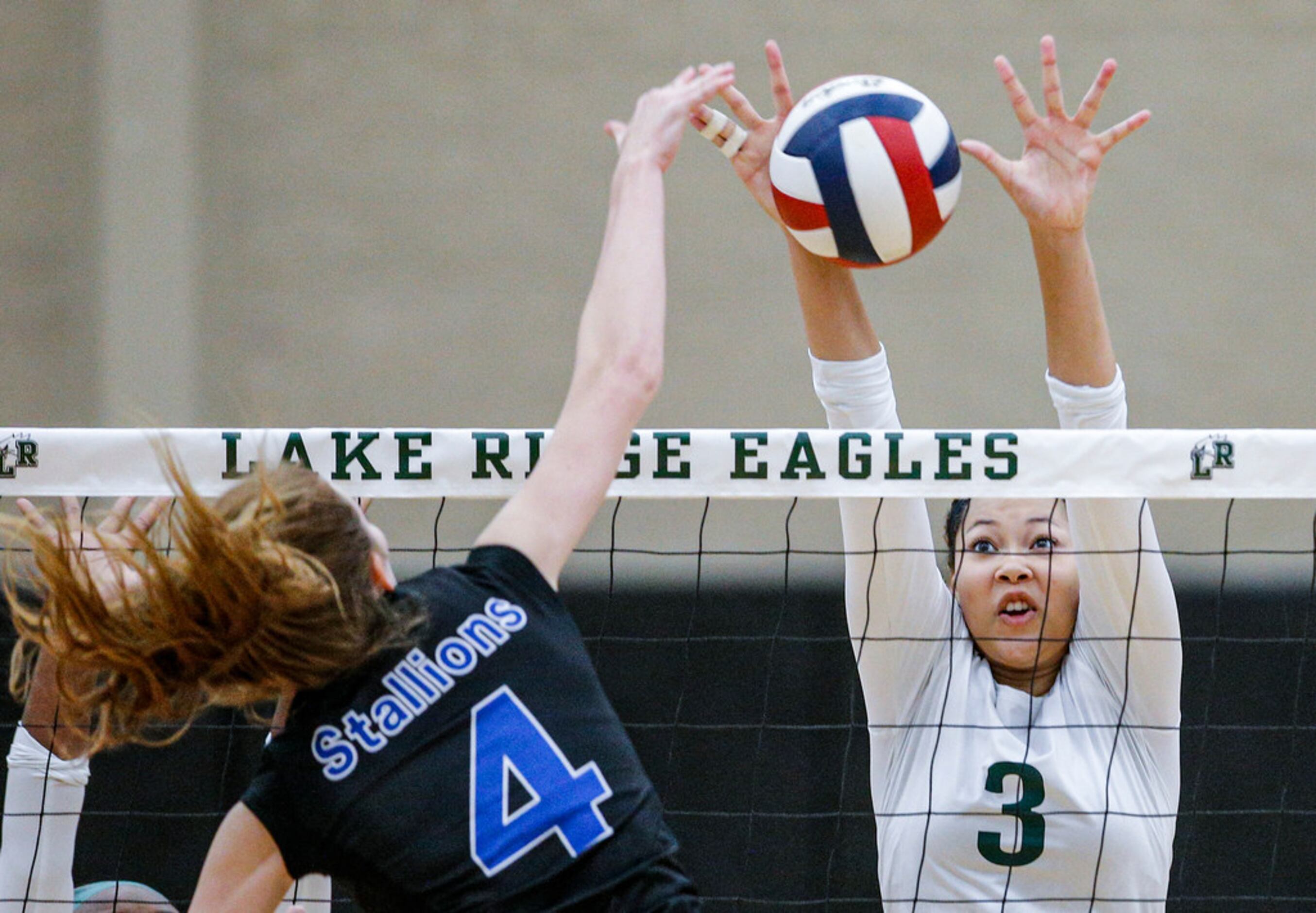 Mansfield Lake Ridge junior Kaelyn Mack (3) attempts to block a spike by North Mesquite...