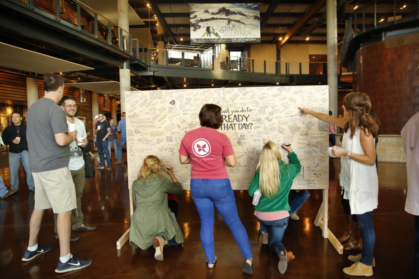 Watermark Community Church employees sign a message board, "What will you do to Be Ready For...