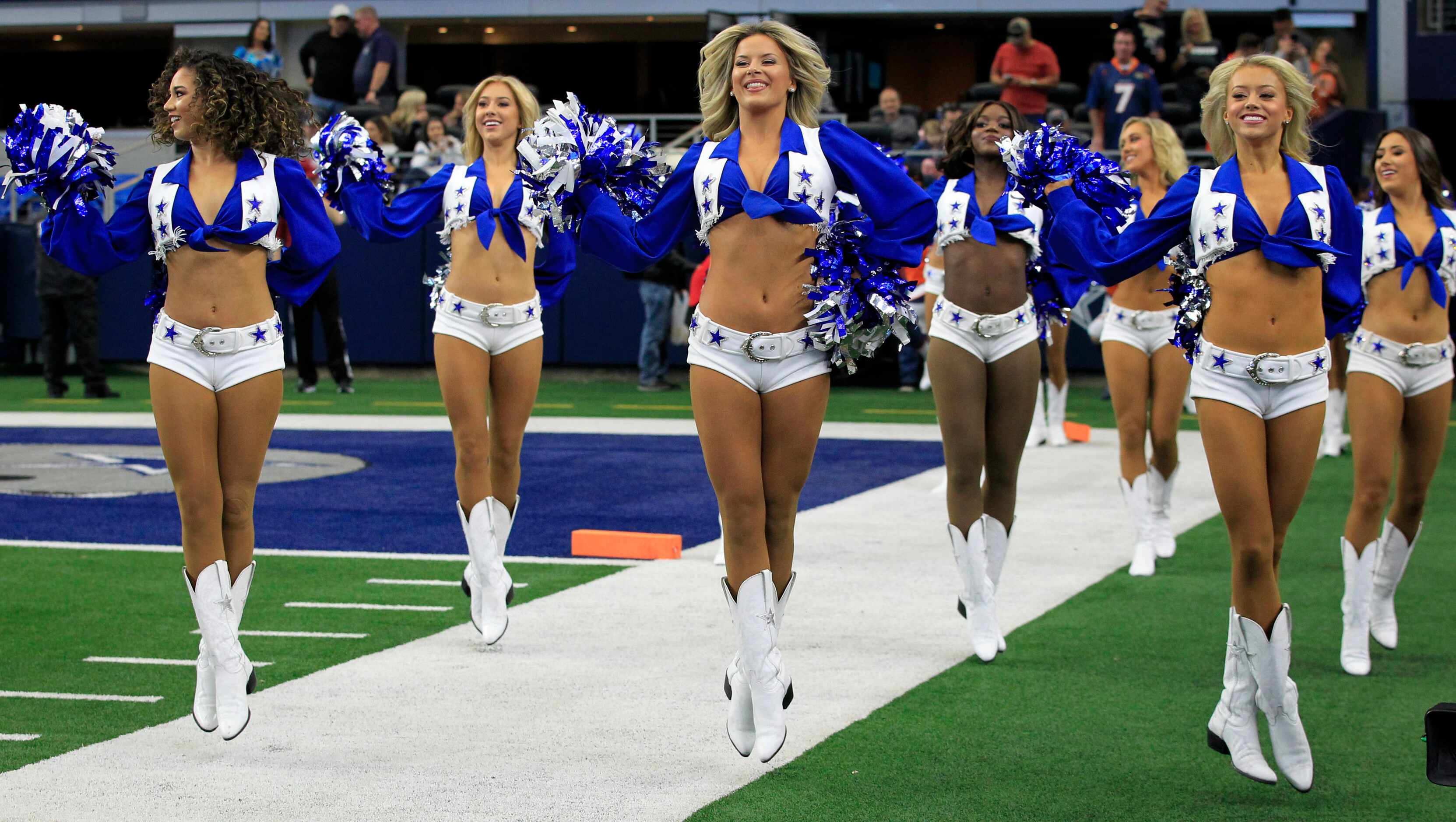 The Dallas Cowboys Cheerleaders seem to float, as they enter the field before the first half...