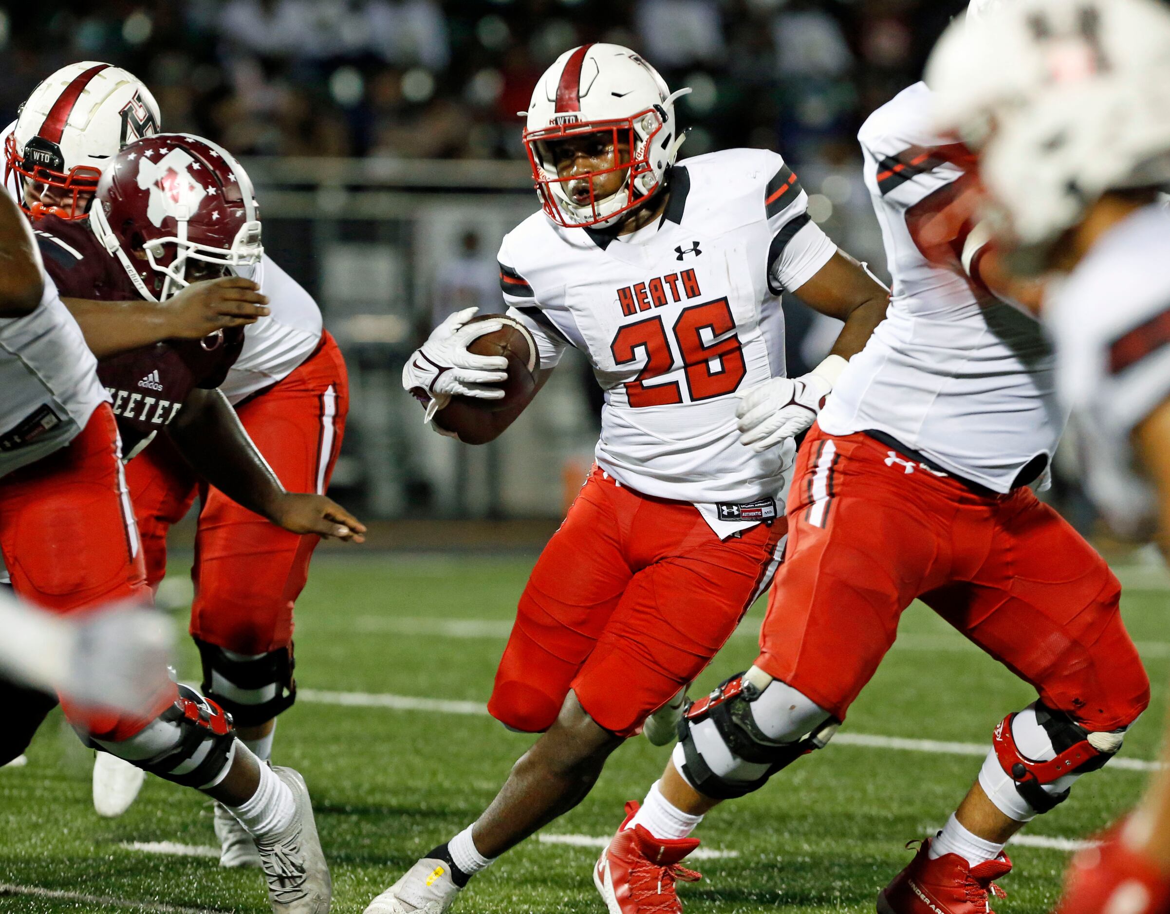 Rockwall Heath RB Zach Evans (26) picks up yards to setup the Hawk’s second touchdown during...