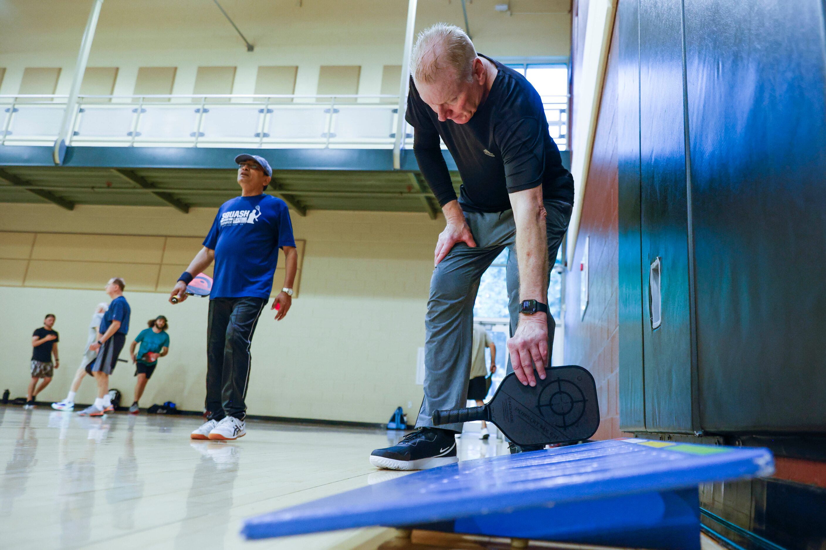 Steve Lawson of Plano puts his paddle on the paddle center after a round of pickle ball game...