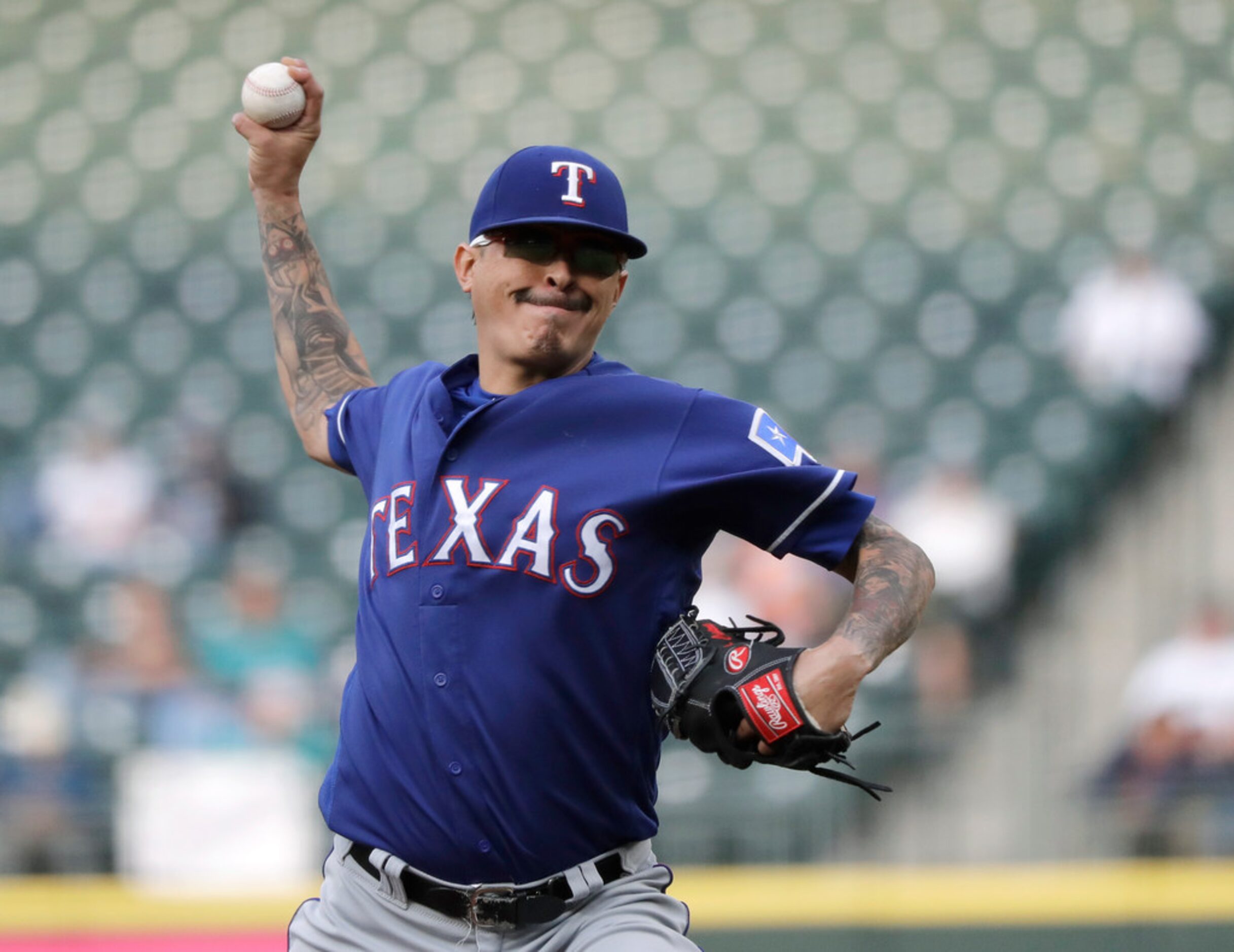 Texas Rangers pitcher Jesse Chavez throws during the first inning of a baseball game against...