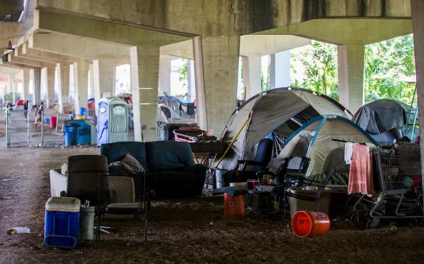 Tents are set up in a homeless encampment under Interstate 30 at Haskell Avenue on Thursday,...
