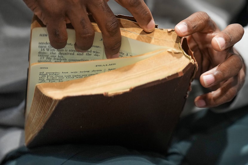 Anthony Armstrong, 44, goes through pages of a copy of  the Bible at St. Jude Center Vantage...