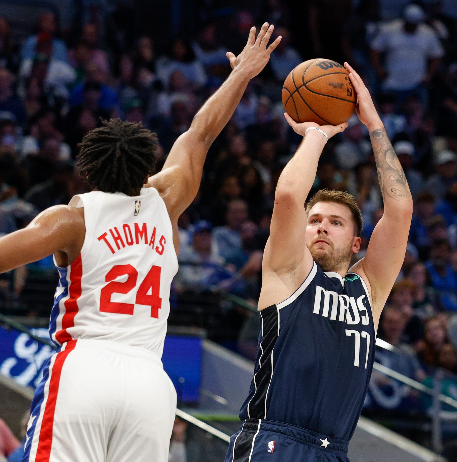 Dallas Mavericks guard Luka Doncic (77) shoots against a defending Brooklyn Nets guard Cam...