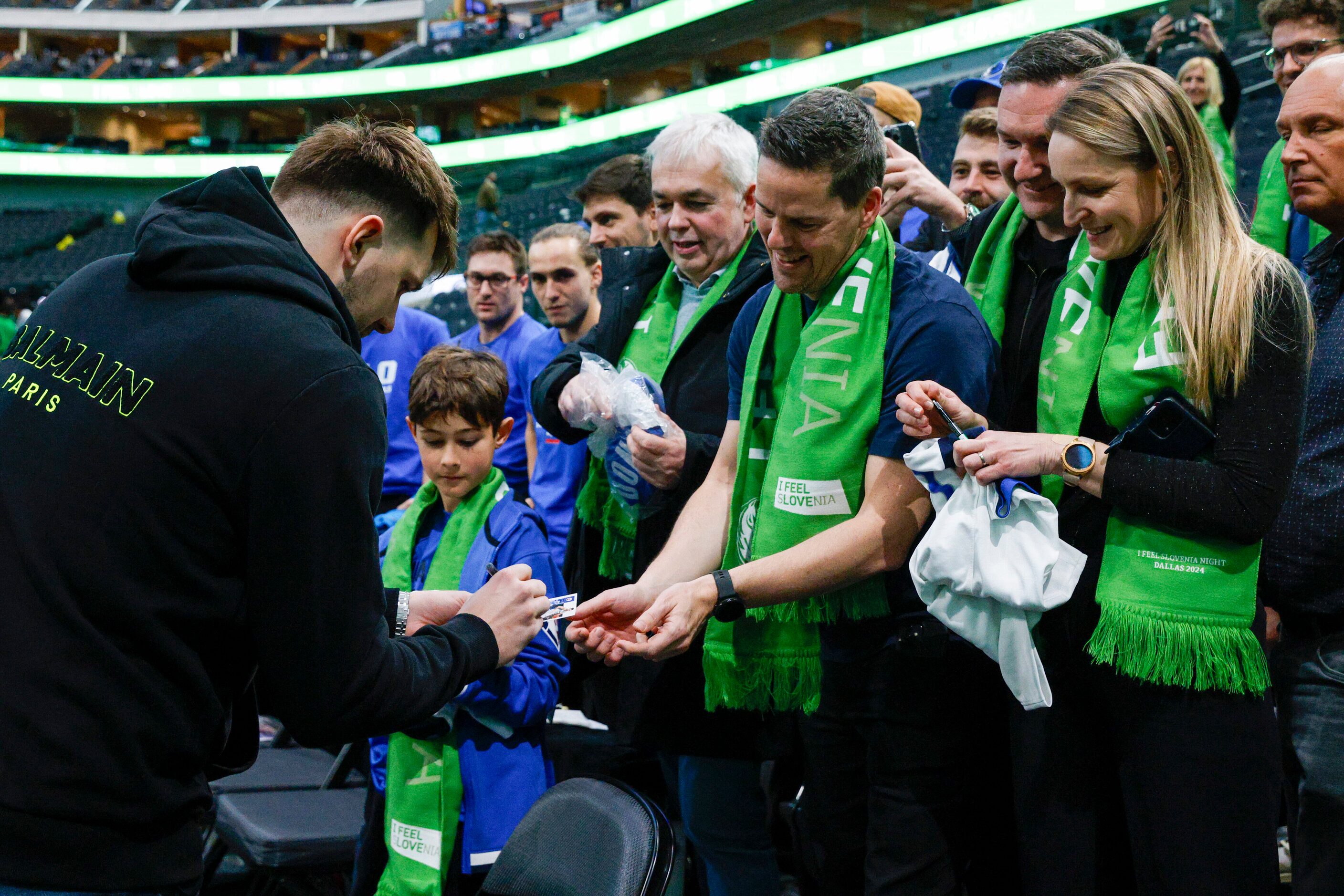 Dallas Mavericks guard Luka Doncic signs autographs for Slovenian fans after an NBA game,...