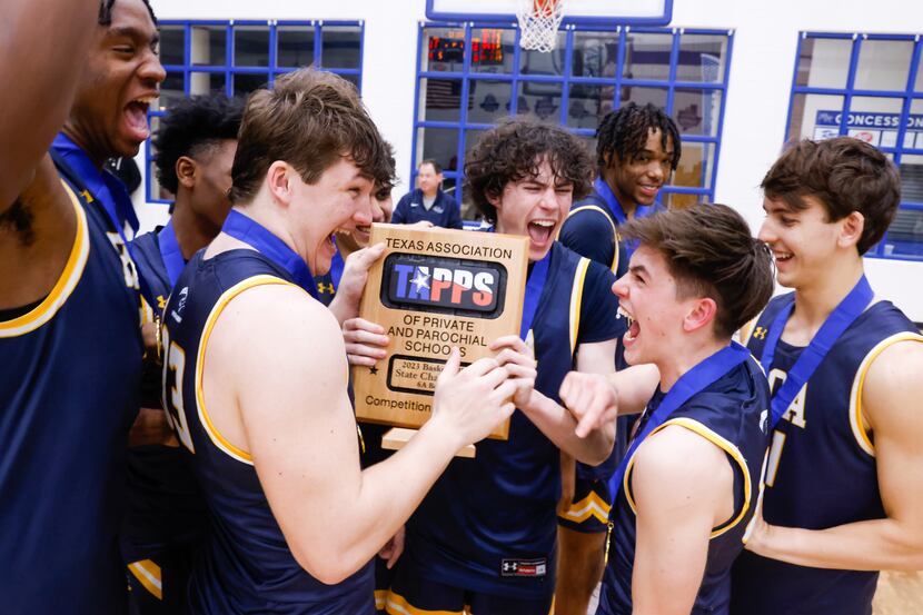 Prestonwood Christian Academy players celebrate winning the TAPPS 6A boys basketball state...