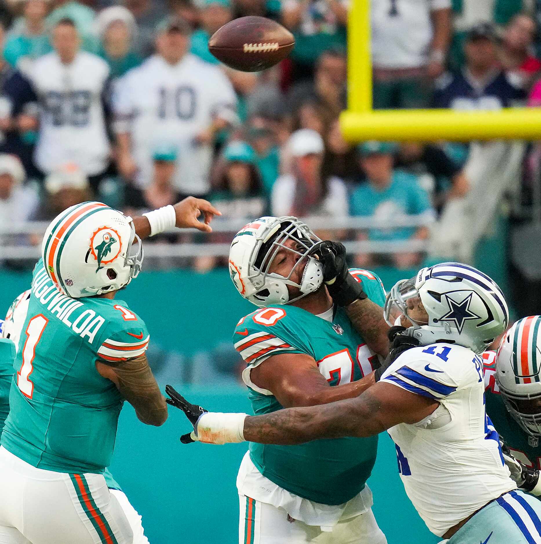 Miami Dolphins quarterback Tua Tagovailoa (1) throws a pass as Dallas Cowboys linebacker...