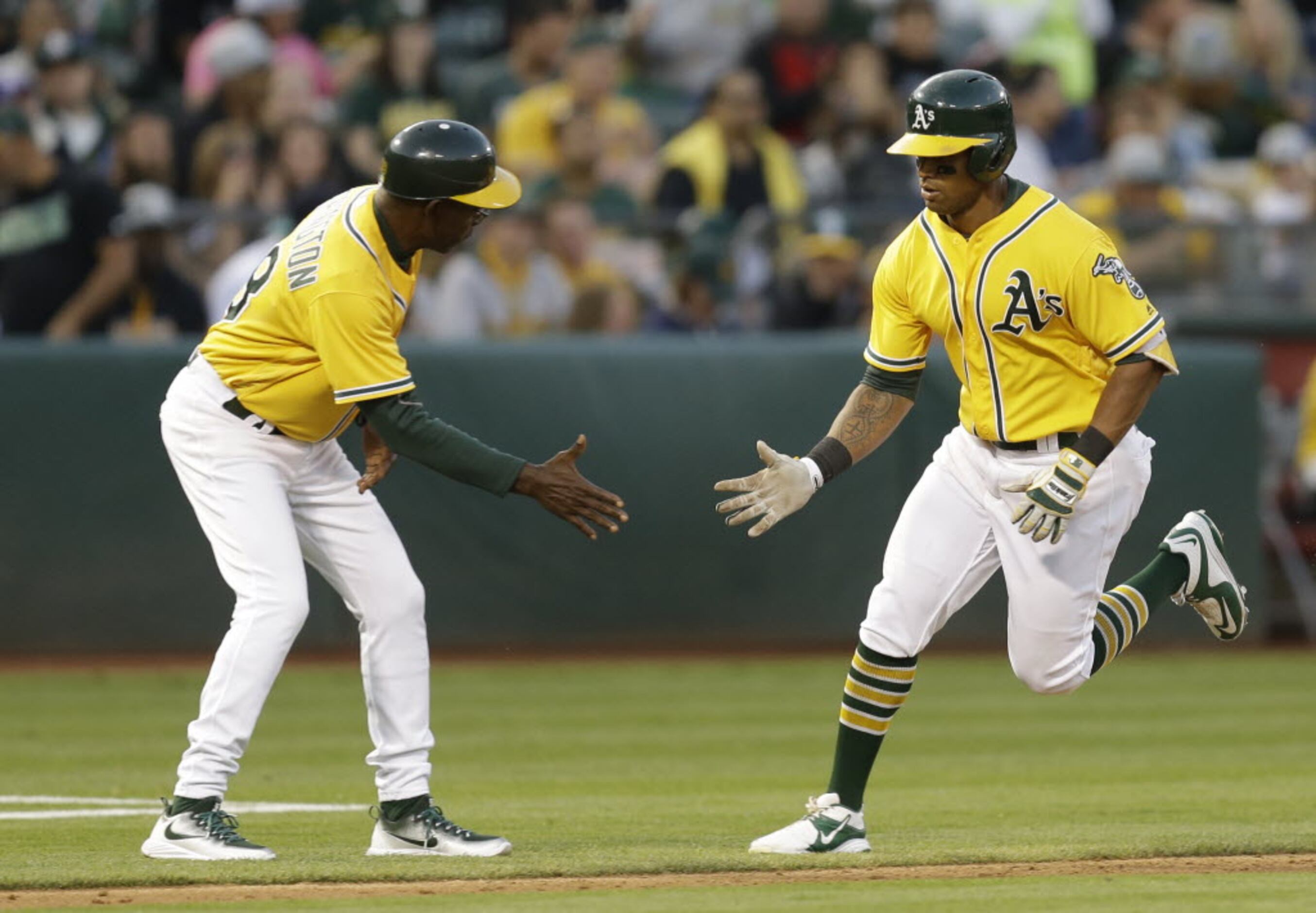 Oakland Athletics' player Reggie Jackson is shown with fans in