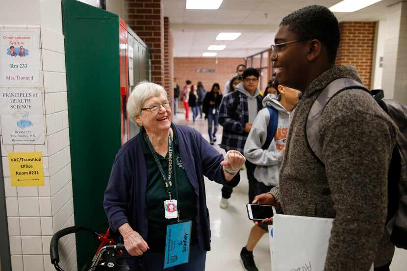Health sciences teacher Sharon Bradley talks with student Blaine Peat in the hallway between...