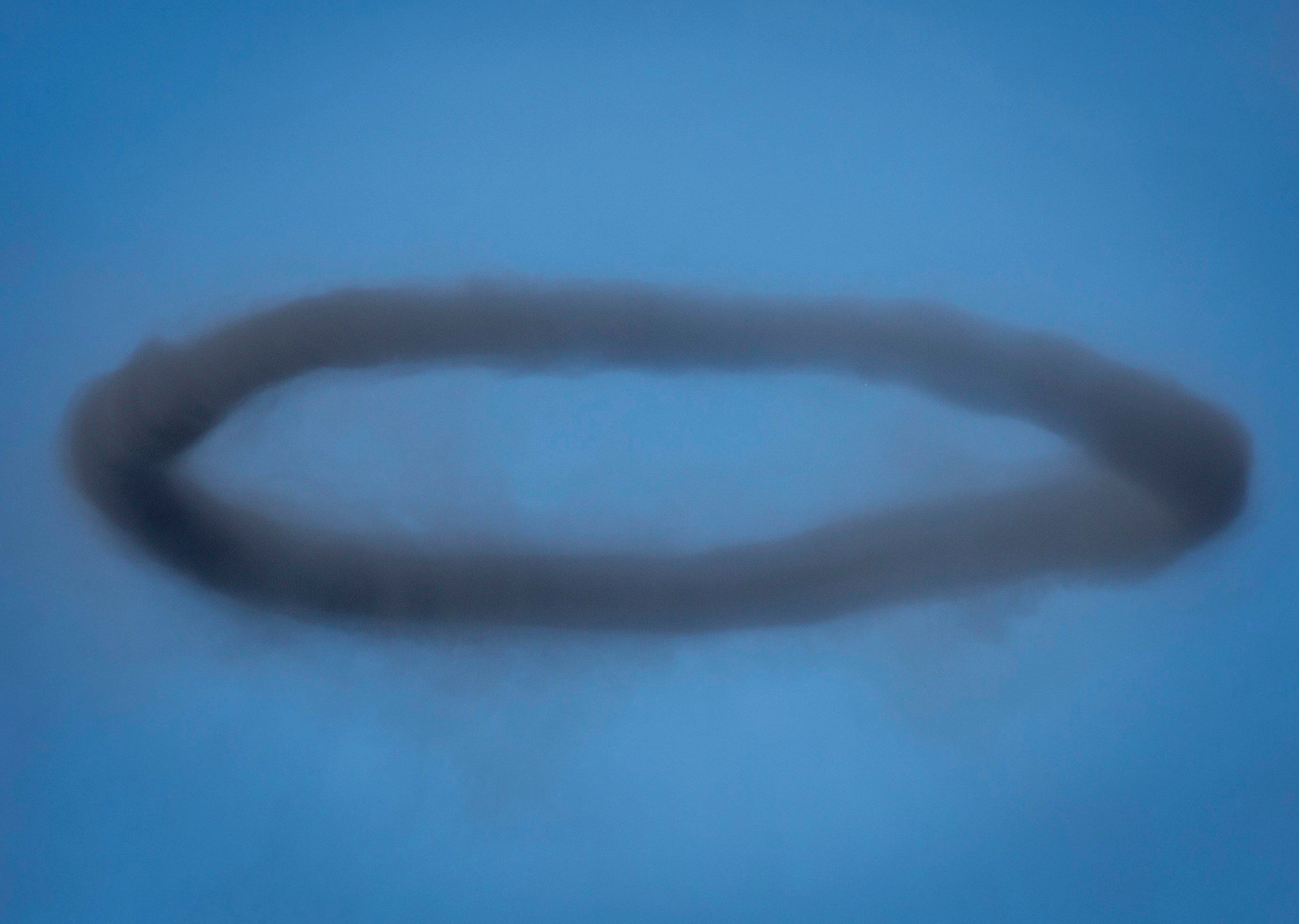 A smoke ring hangs in the air during the Commemorative Air Force Wings Over Dallas WWII...