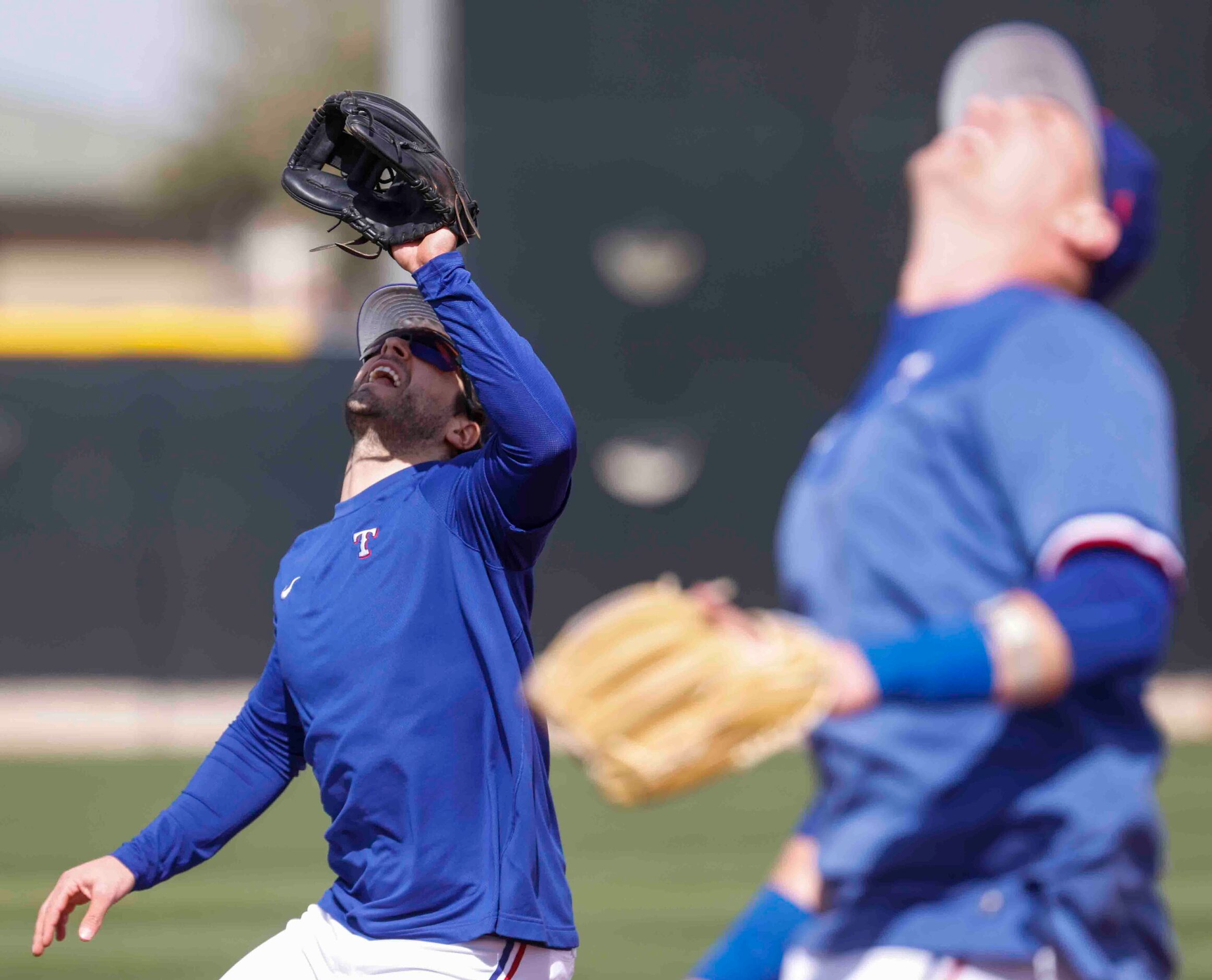 Texas Rangers infielders Josh Smith, left, and Josh Jung, look to catch a ball during a...