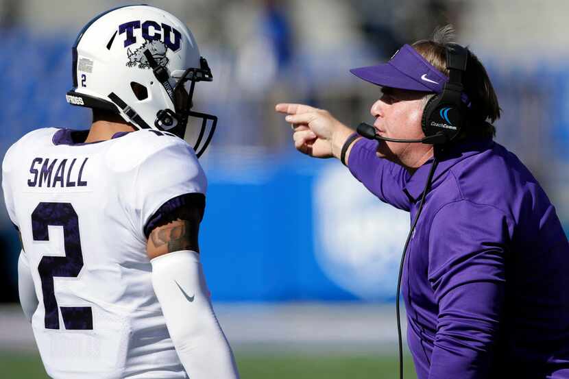 TCU head coach Gary Patterson, right, talks with safety Niko Small (2) during the first half...