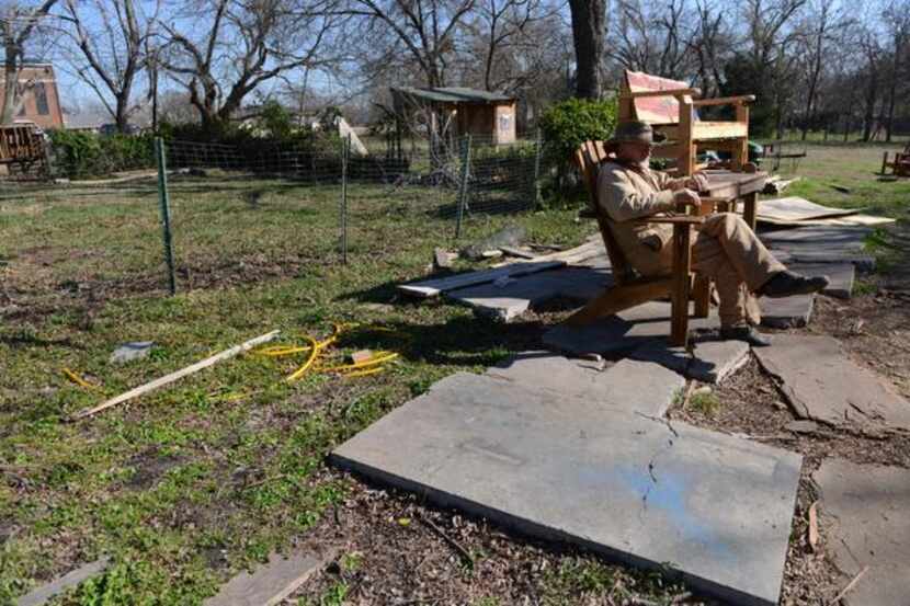 
Chris Mayes sits on one of the wooden chairs he has made in his backyard wood shop. 
