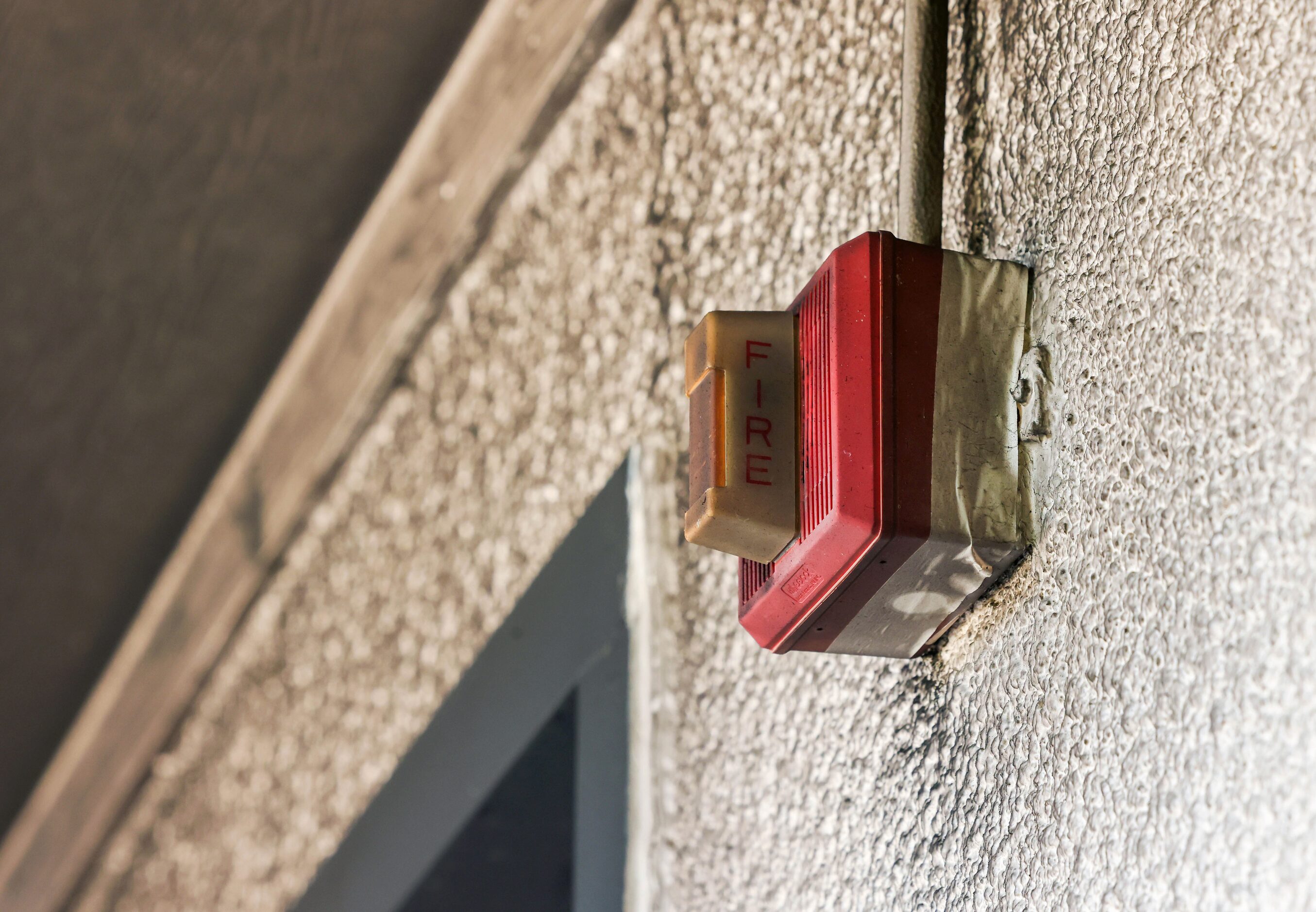 A fire alarm is warped and darkened above the doorway of Community Unitarian Universalist...