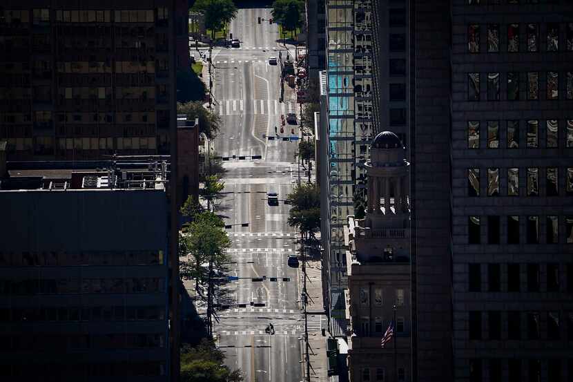 The typically congested Main Street in downtown Dallas shows the effect of coronavirus and...