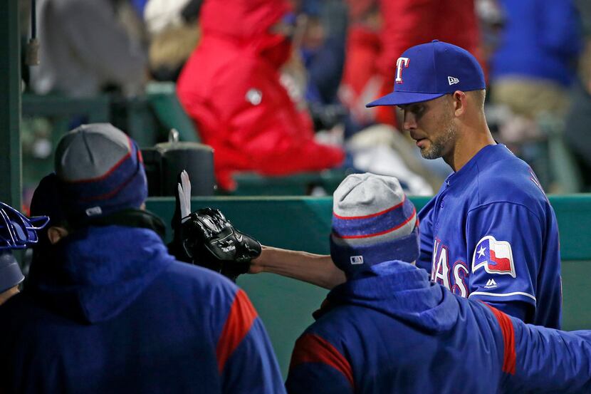 Texas Rangers starting pitcher Mike Minor, right, walks to the dugout after giving up one...