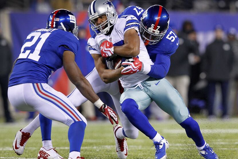 Dallas Cowboys wide receiver Miles Austin (19) fights for extra yards after a catch on the...