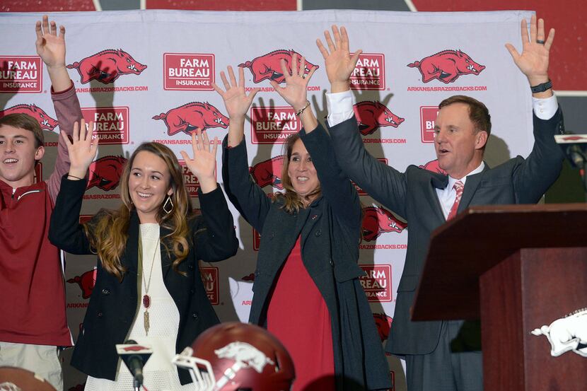 Newly hired University of Arkansas NCAA college football head coach Chad Morris, right, is...