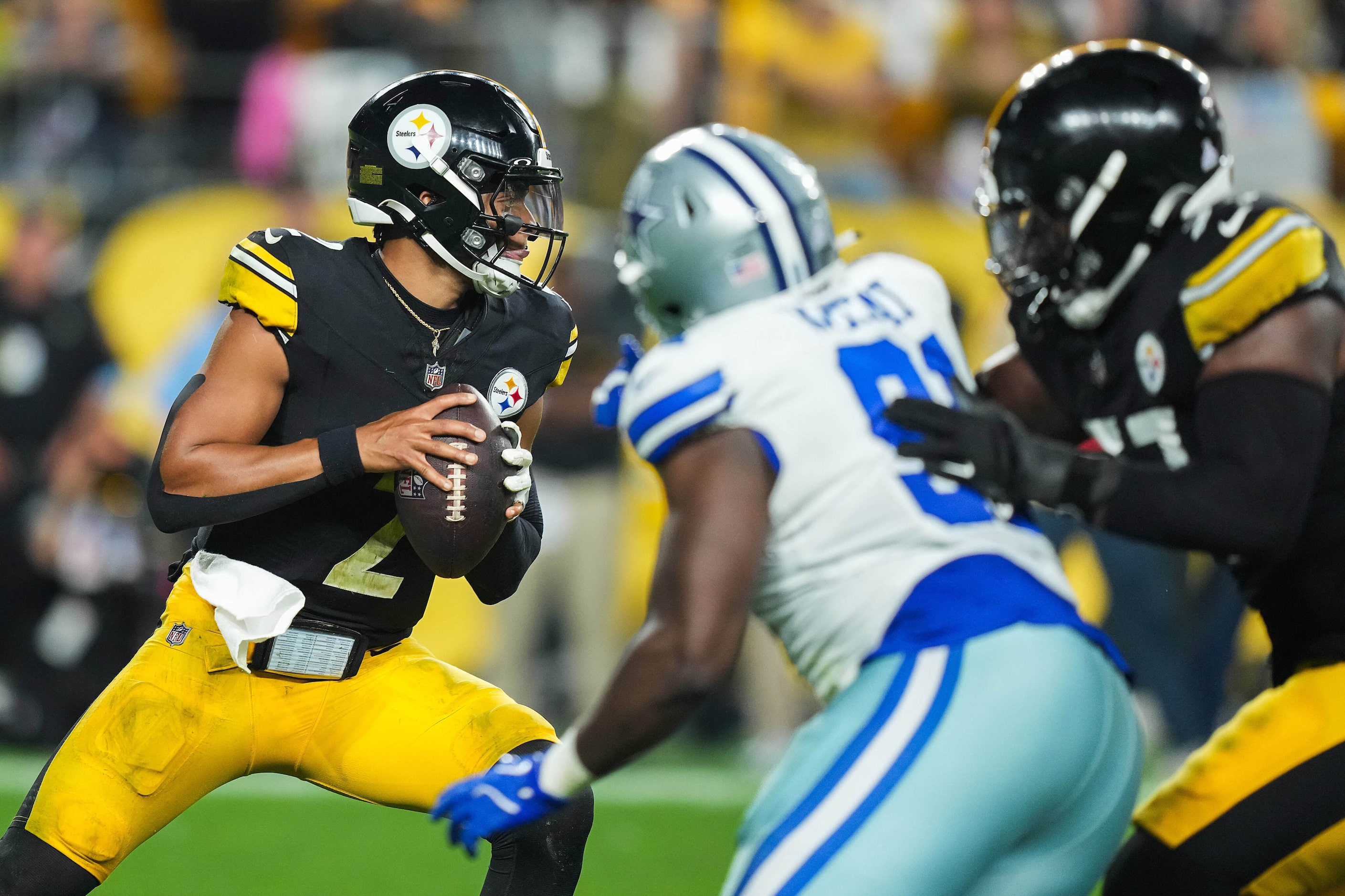 Pittsburgh Steelers quarterback Justin Fields (2) looks to pass under pressure from Dallas...