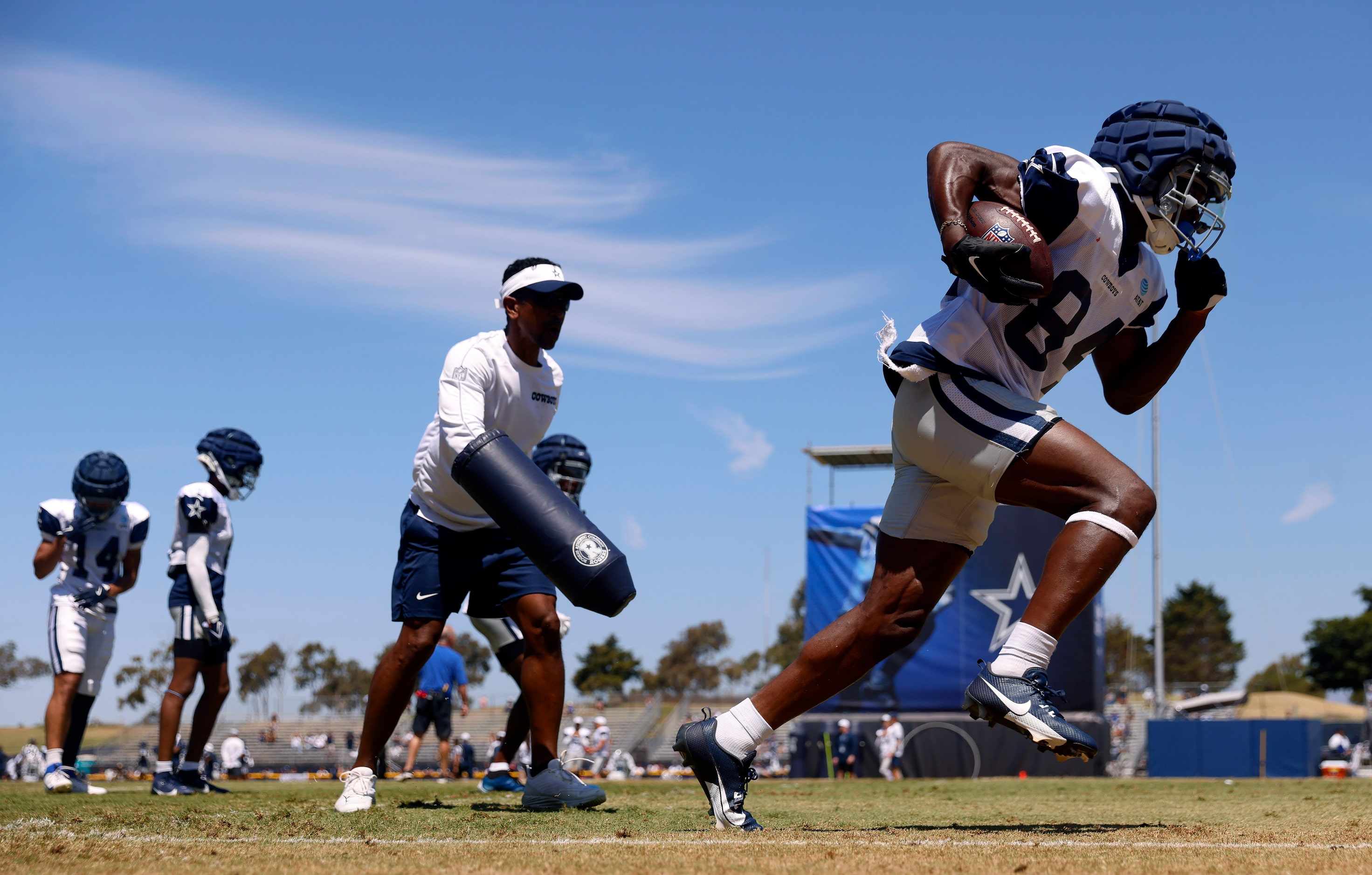 Dallas Cowboys wide receiver Kelvin Harmon (84) turns up field along the sideline after he’s...