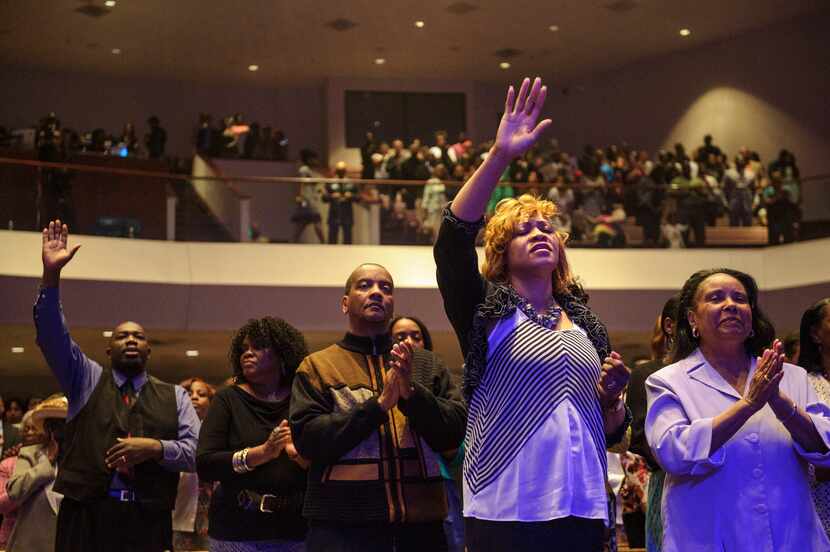 Parishioners worship in the congregation during at Oak Cliff Bible Fellowship's presentation...