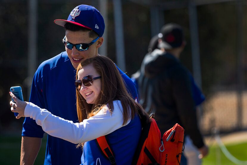 11:04 AM --  Robinson pauses to poses for a selfie with a fan while going between stations...