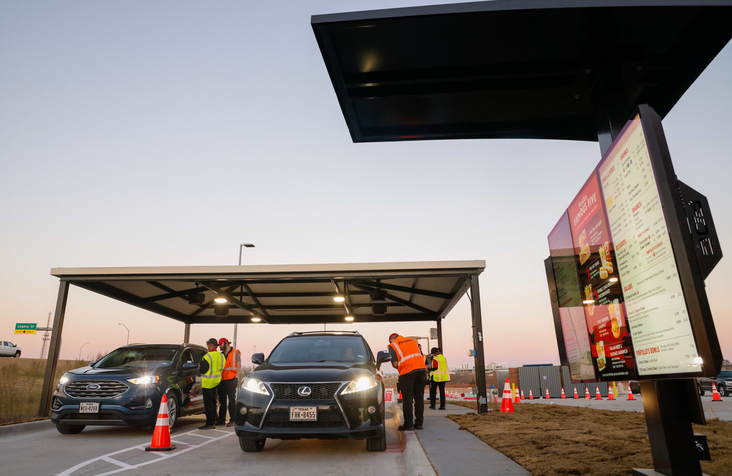 Customers order from their cars in the drive-thru of Portillo’s in The Colony on Monday,...