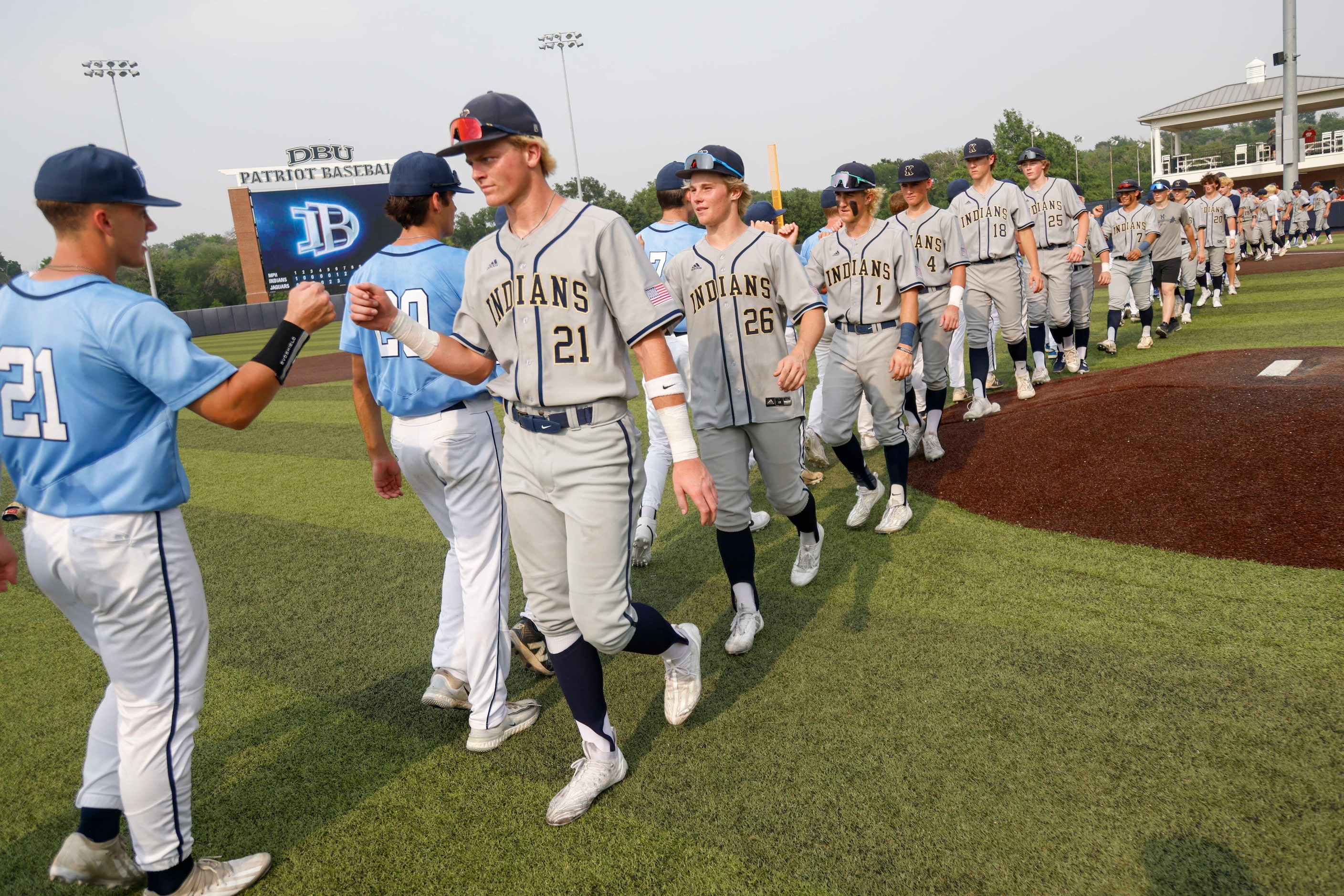 Flower Mound player Sam Erickson (21) and Keller player Cole Koeninger (21) fist bump...