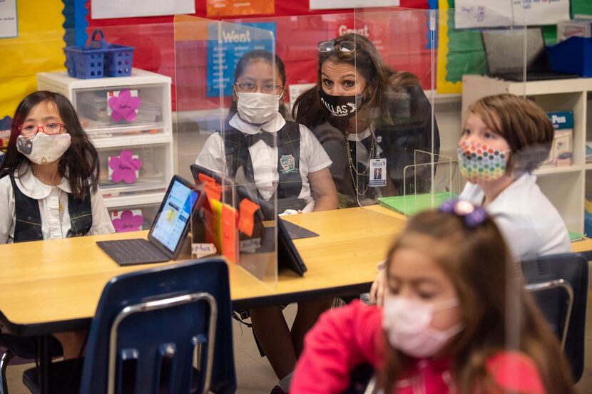 Susana Cordova, DISD deputy superintendent, speaks with second grader Kaylee Rosas about her...