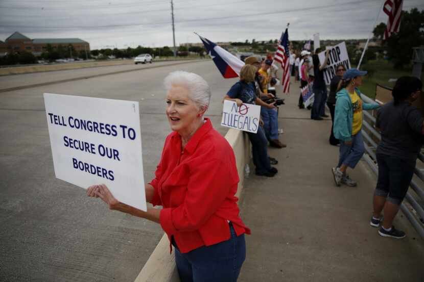 Lynda Thomas, of Melissa, Texas, and a member of the McKinney Tea Party, holds a sign during...