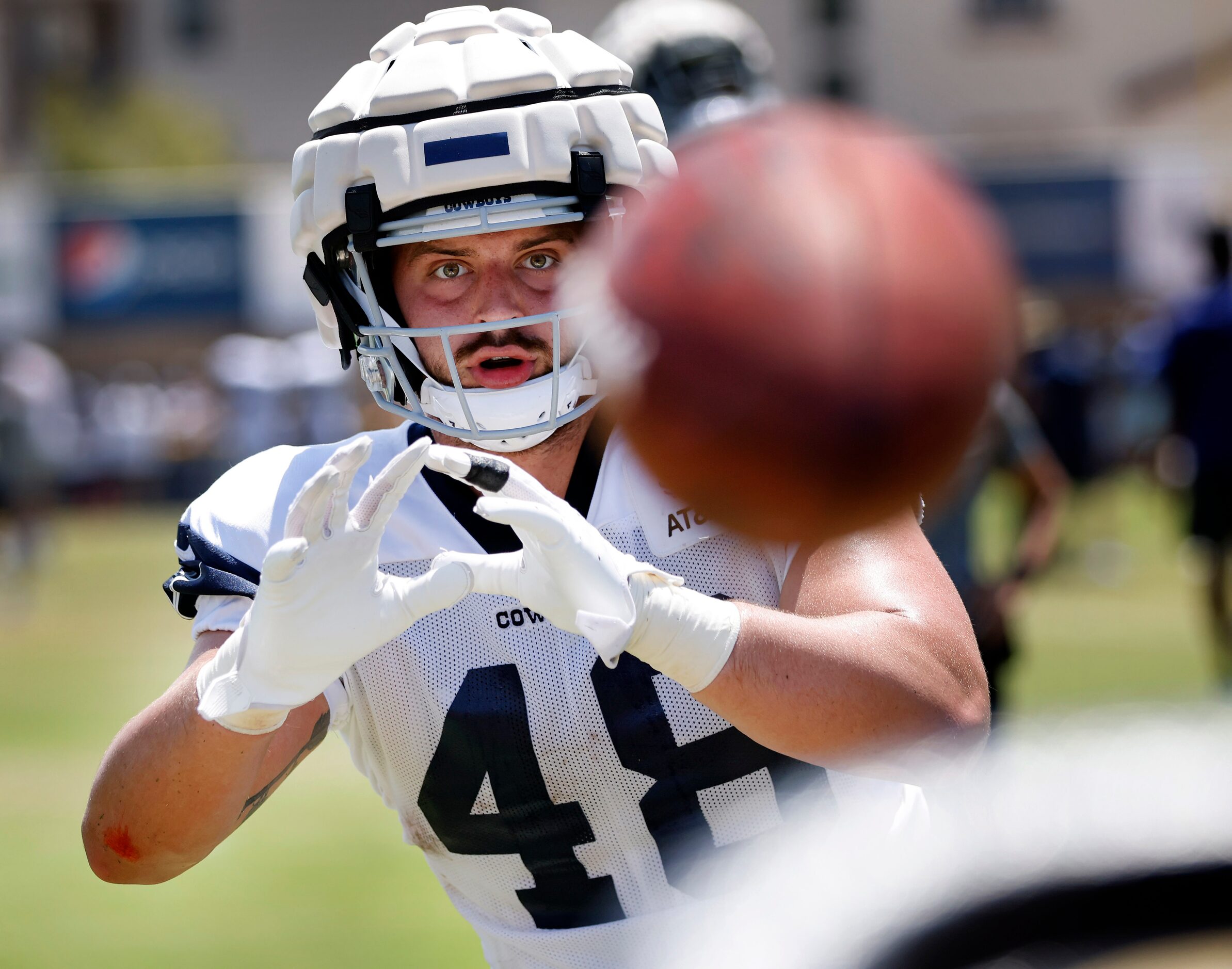 Dallas Cowboys tight end Jake Ferguson (48) catches footballs thrown form a machine during...